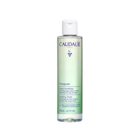 Caudalie Vinopure toner bottle close-up showing purifying action on pores.