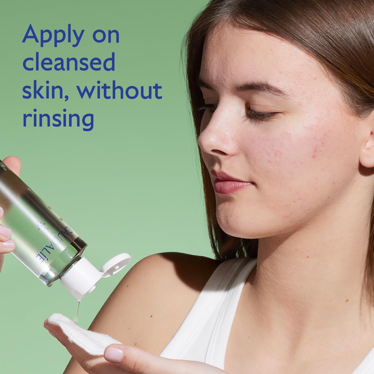 Caudalie Vinopure toner pouring on cotton pad for routine use.