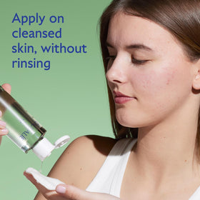 Caudalie Vinopure toner pouring on cotton pad for routine use.