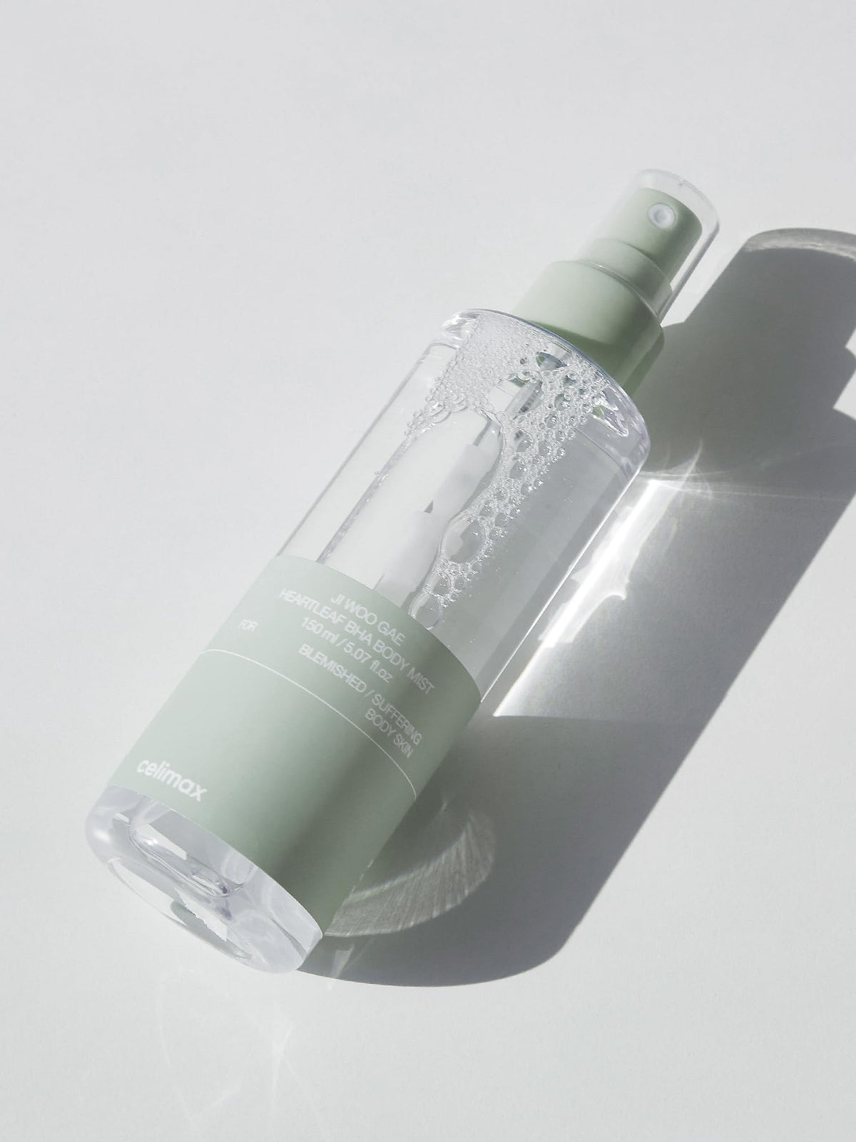 Celimax Heartleaf BHA Body Mist sprayed on the back for back coverage.