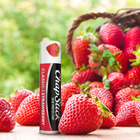 ChapStick strawberry flavor closeup emphasizes fruity scent and tint readiness.