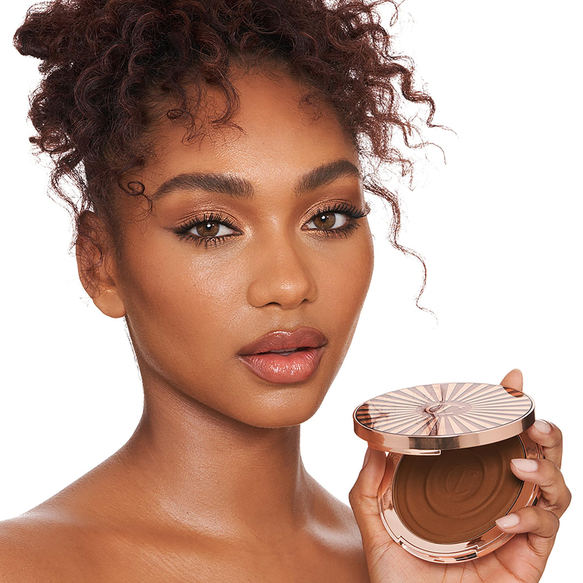 Charlotte Tilbury bronzer texture close-up showing creamy, hydrating formula