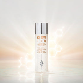 Applying Glow Toner with pad to refine pores and prep skin.