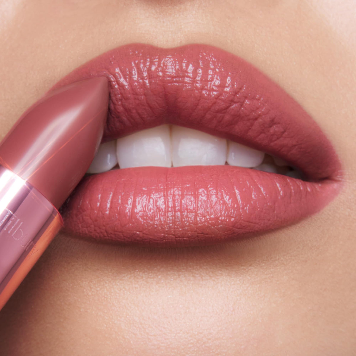 Applying Charlotte Tilbury Kissin g Lipstick 90s Pink for hydrated lips