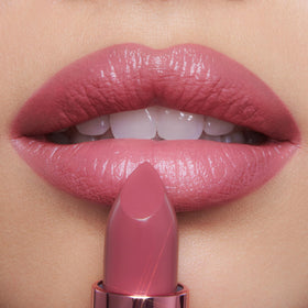 Rose to Fame lipstick tube with pink metallic cap close-up.