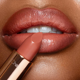Packaging shot of Charlotte Tilbury K.I.S.S.I.N.G Lipstick for on-the-go elegance.