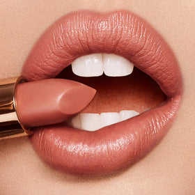 Charlotte Tilbury K.I.S.S.I.N.G Lipstick on lips demonstrates full-bodied pout with satin glow.