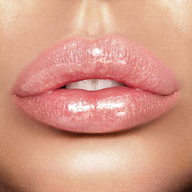 Charlotte Tilbury Lip Lustre lotus-extract conditioning close-up showing smoothing hydration.