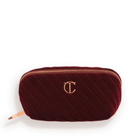 Charlotte Tilbury medium travel makeup bag in night crimson velvet exterior for elegant organization
