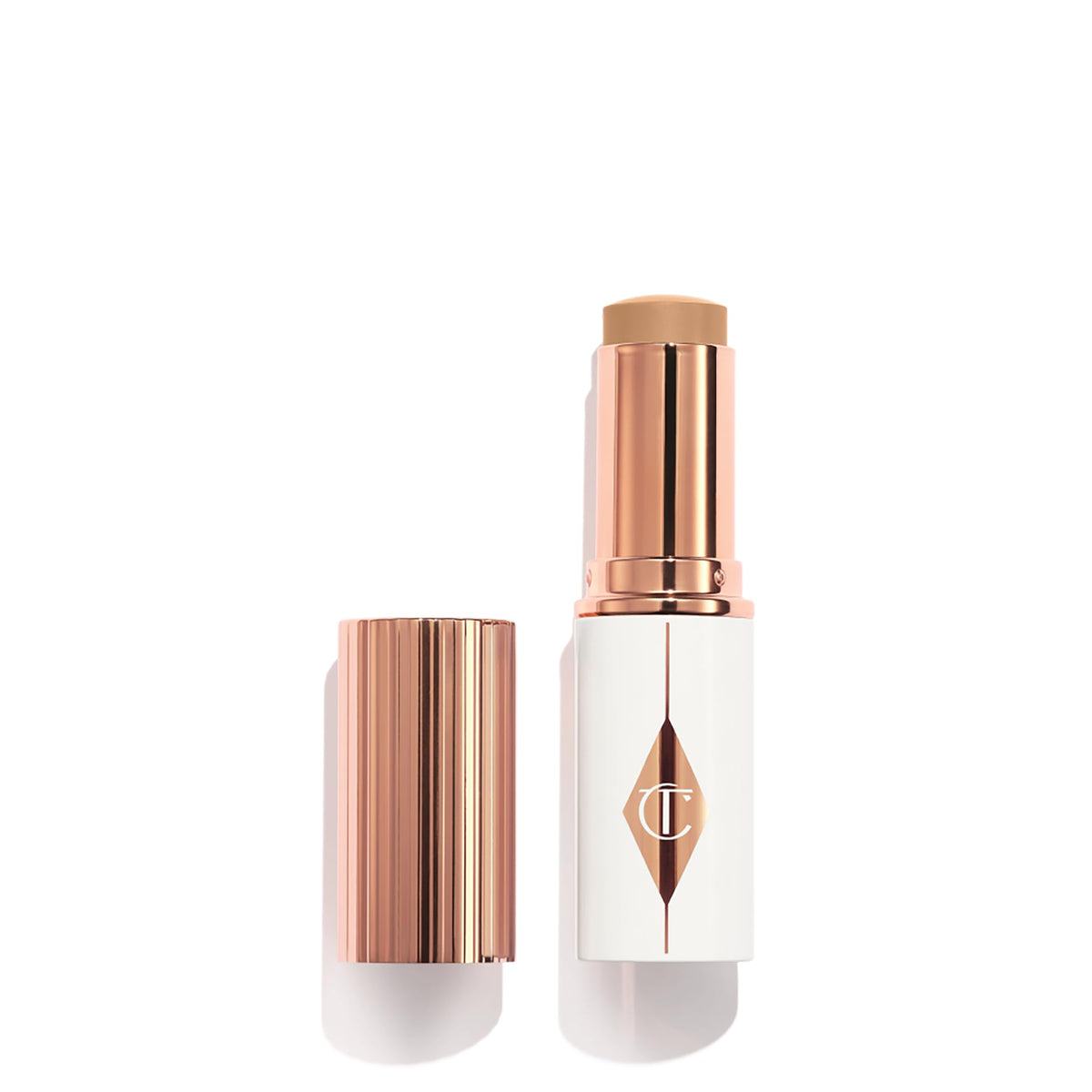 Charlotte Tilbury Unreal Skin Tint bottle close-up with radiant glow.