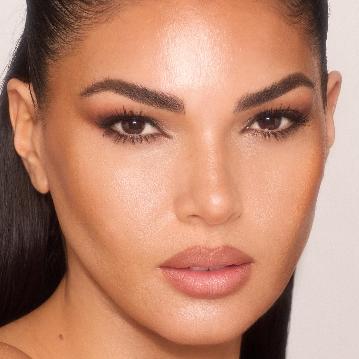 Charlotte Tilbury Unreal Skin Tint hydration sheen delivering dewy glow.