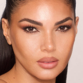 Charlotte Tilbury Unreal Skin Tint hydration sheen delivering dewy glow.