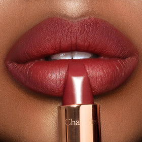 Charlotte Tilbury Walk Of No Shame lips swatch showing soft modern matte glow.