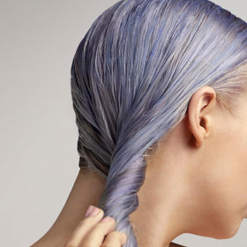 Color-correcting violet pigments reduce brassy tones in Christophe Robin product.