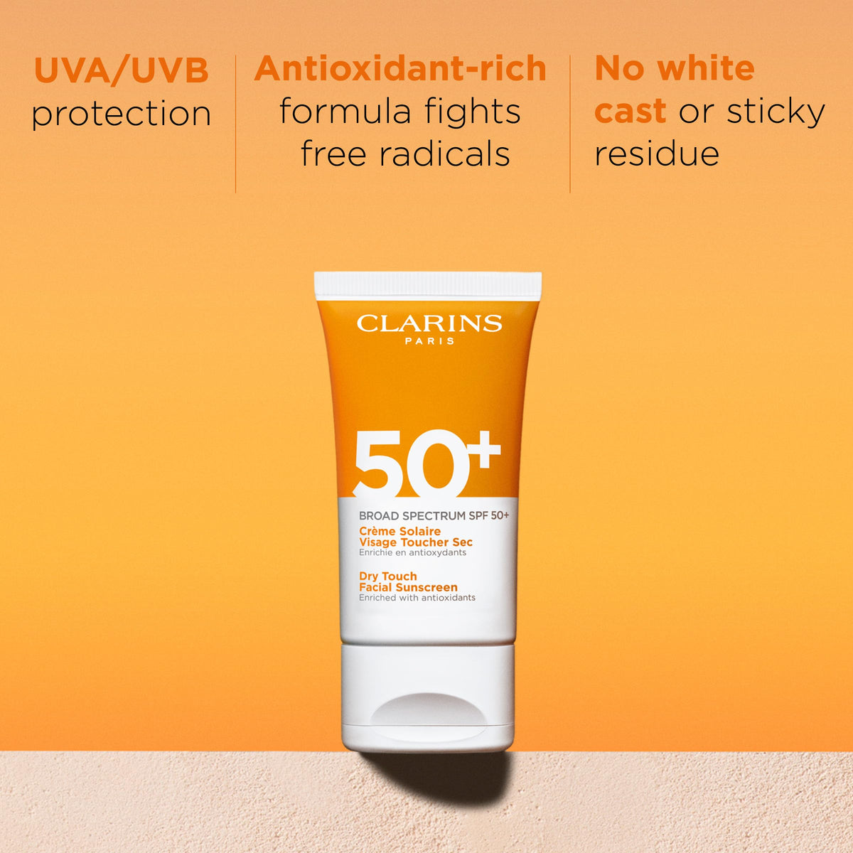 Clarins Dry Touch sunscreen on hand demonstrates easy application.