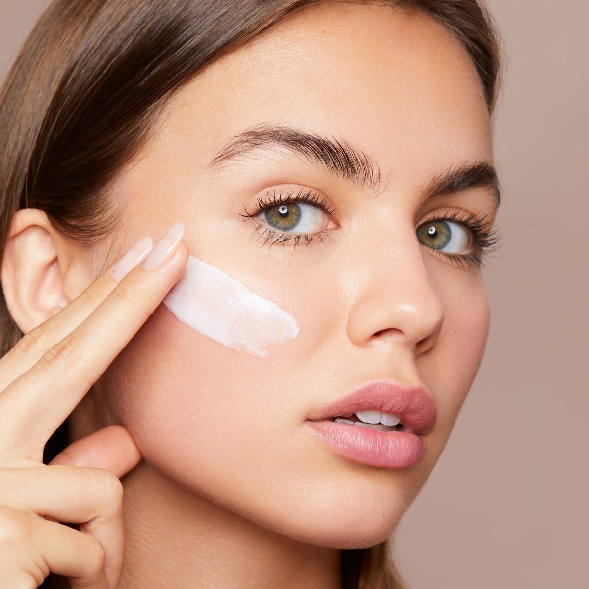 Applying Clarins Hydra-Essentiel on the face for quick absorption