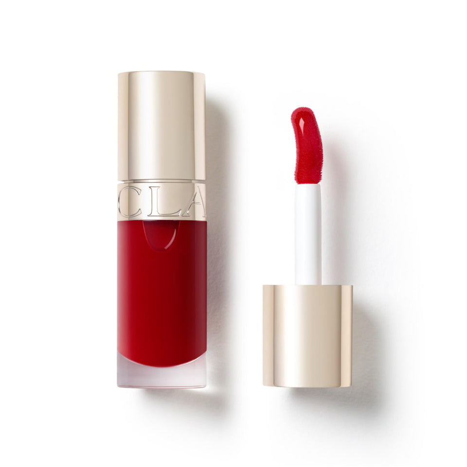 Clarins Lip Comfort Oil soft shine on lips for hydrated, glossy color.