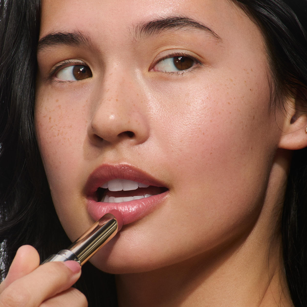 Clarins Lip Oil Balm top lipstick demonstrates lasting shine over color.