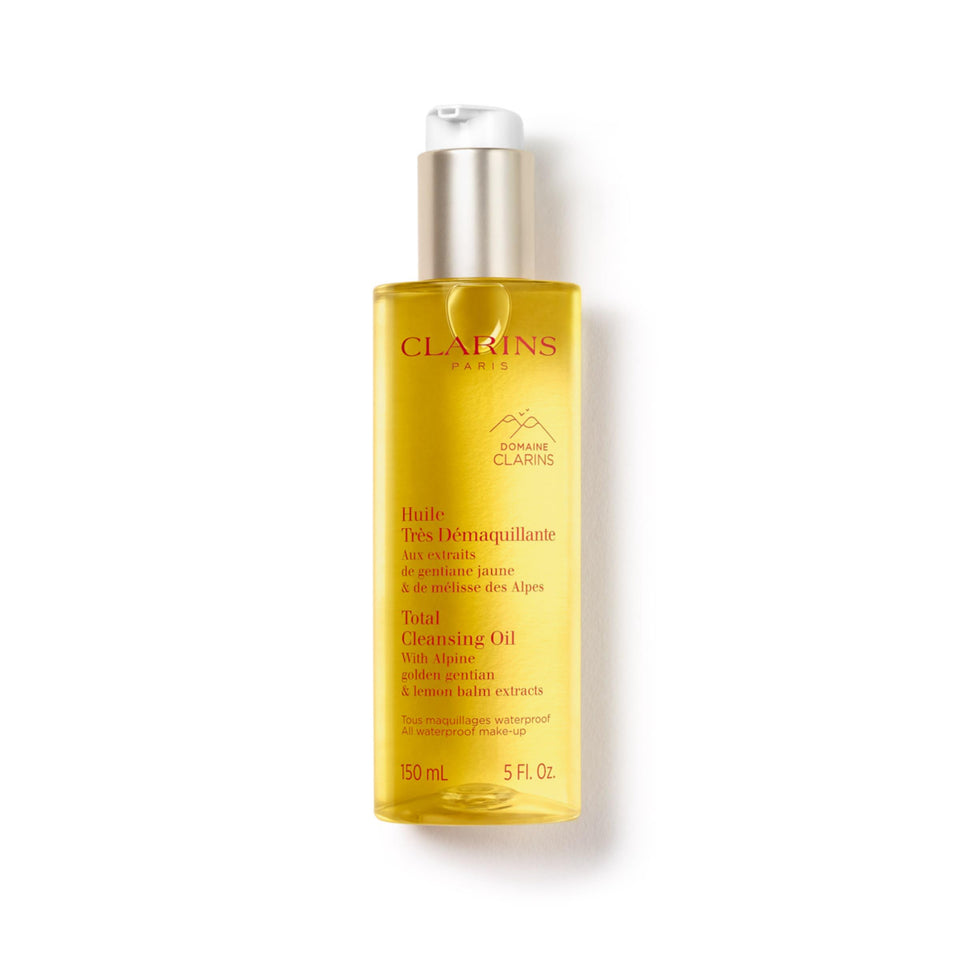 Clarins Total Cleansing Oil bottle being poured for easy makeup removal.