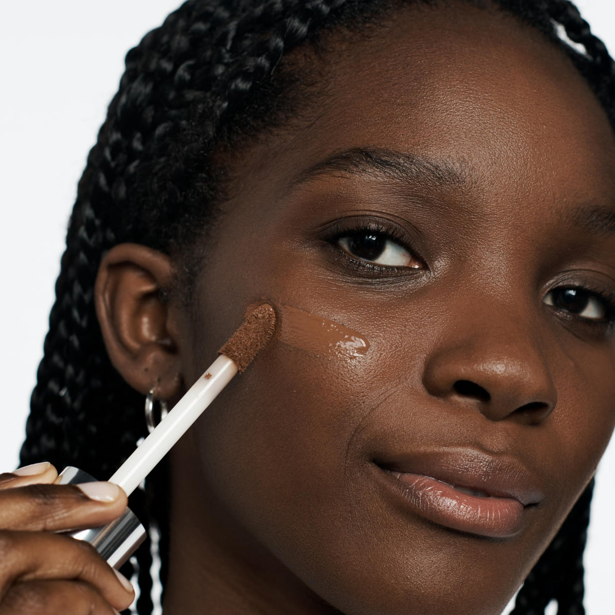Clinique Beyond Perfecting bottle with cap demonstrates hygienic application.