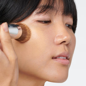 Clinique buffing brush used from the center of the face outward for a seamless finish.