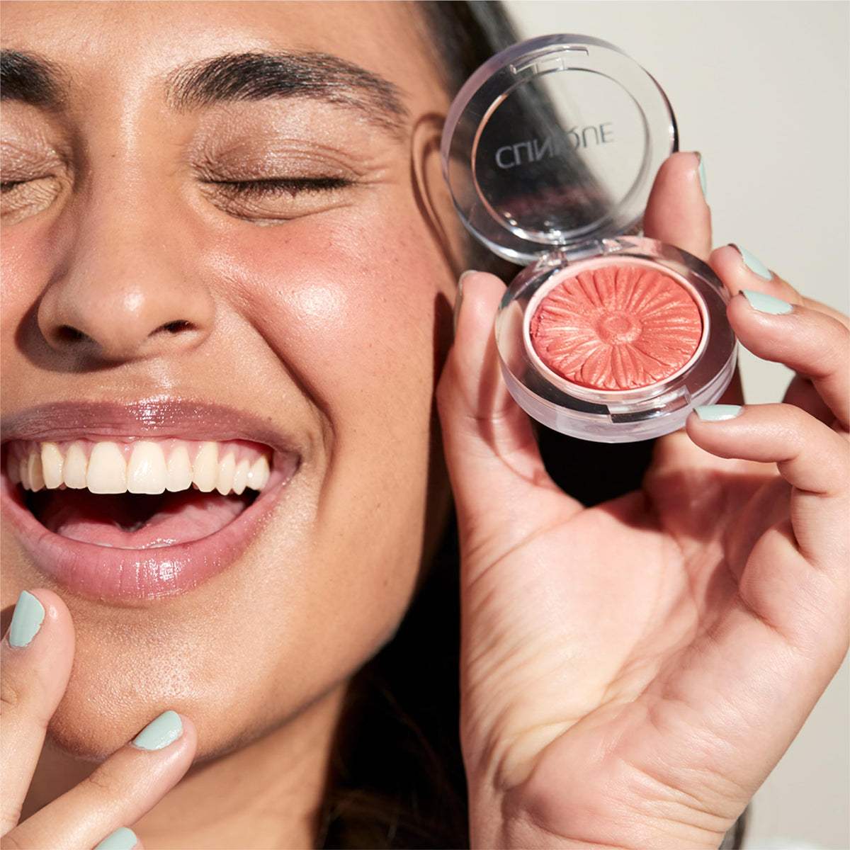 Cola Pop swatch on apples of cheeks shows bright, natural flush