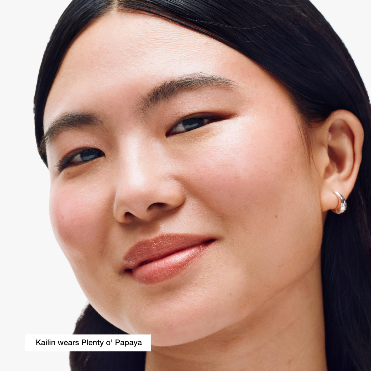 Creamy texture of Clinique blush stick blending on cheek for natural flush.