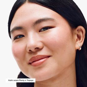 Creamy texture of Clinique blush stick blending on cheek for natural flush.