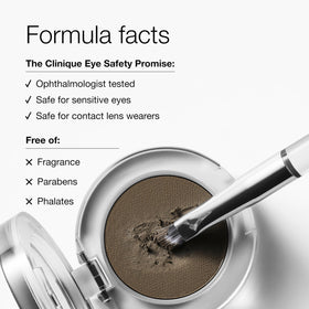Applying Clinique Brow Pomade with a brush to shape brows naturally.