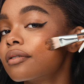 Clinique Foundation Blending Brush center-to-outward blend for natural finish.