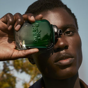 Coach Green bottle close-up with wooden cap hints natural luxury