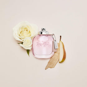 Side view of Coach Signature EDT bottle highlighting suede and sandalwood accents