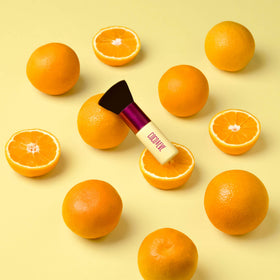 Coco & Eve Sunny Honey Bali Bronzing Foam on the face for even coverage.