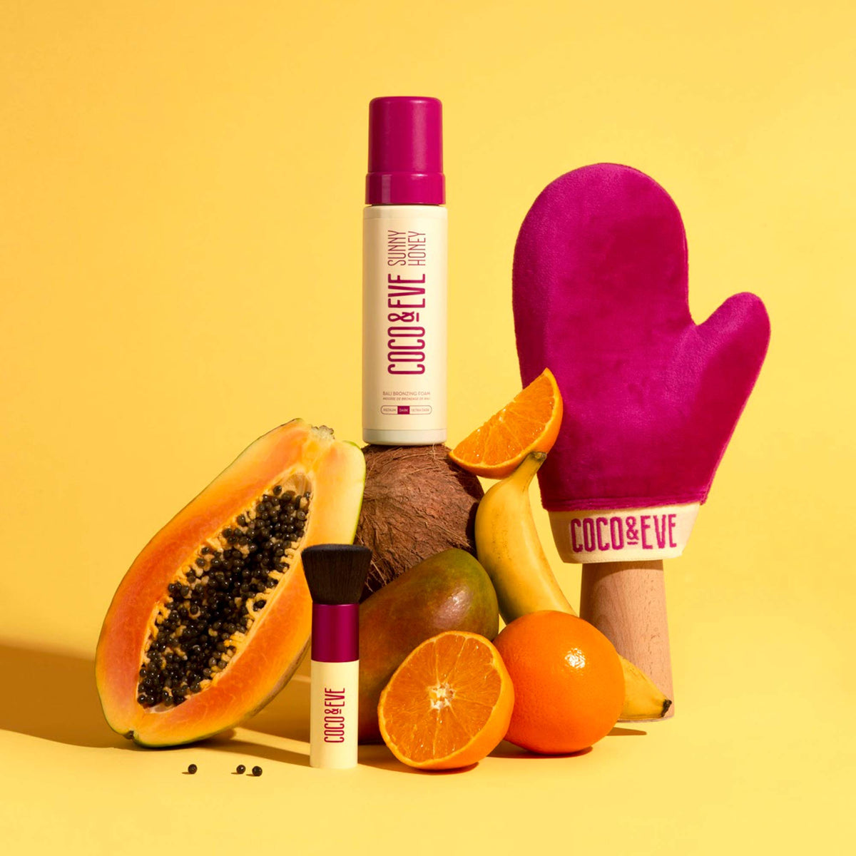 Coco & Eve Sunny Honey Deluxe Vegan Kabuki Brush with ergonomic handle.