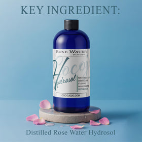 Close-up of rose petals beside Cocojojo hydrosol suggesting natural fragrance and purity.
