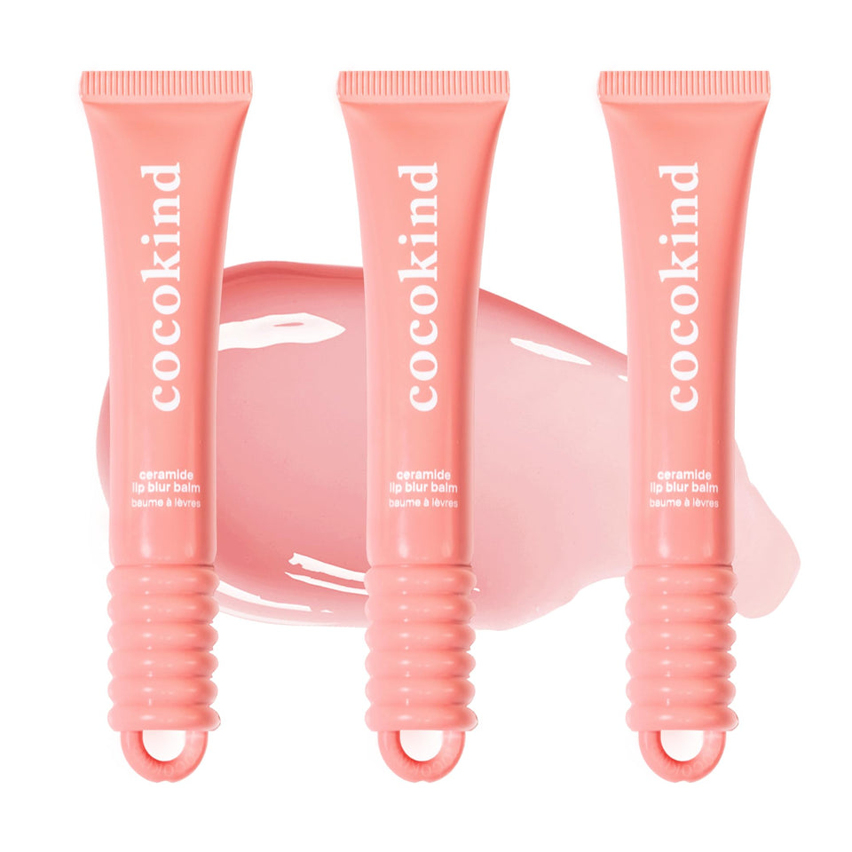 Cocokind Ceramide Lip Blur Balm Be Kind coral pink tube gliding on lips for hydration