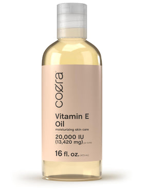 Coera Vitamin E Oil bottle pour demonstrates smooth skin hydration.