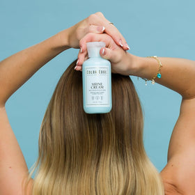 Color Edge Shine Cream Detangler label close-up highlighting carrot seed oil and aloe ingredients.