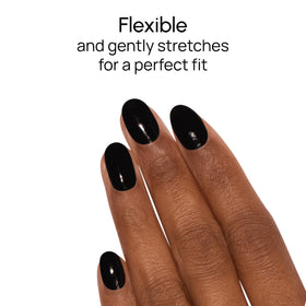 Hands mid-application of Color Street Midnight in Manhattan strips for quick use.