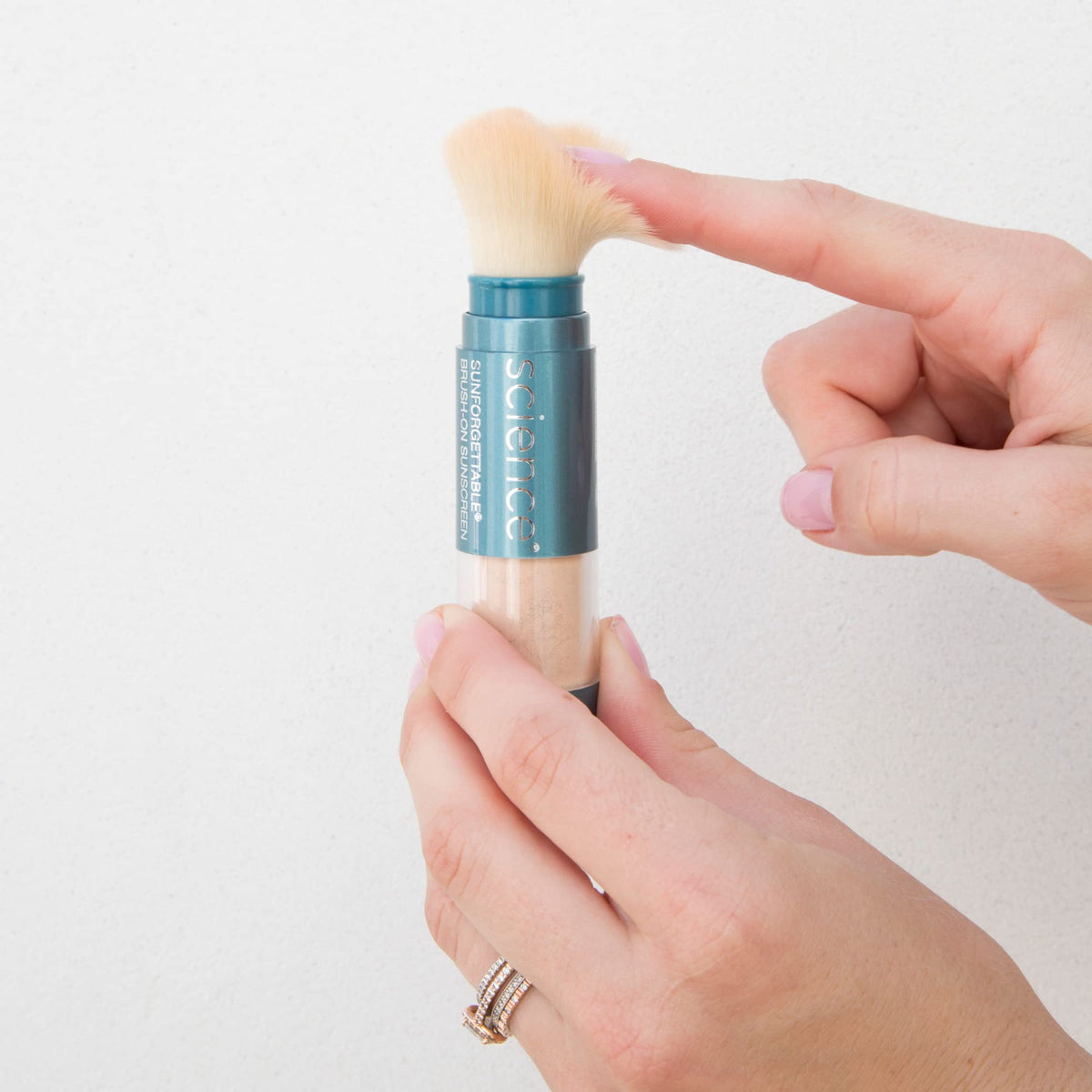 Colorescience brush-on sunscreen mineral powder deep shade during application for sheer coverage
