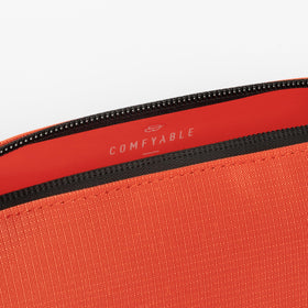 Comfyable cosmic orange bag ready for light overnight travel with toiletries