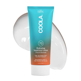 COOLA SPF 70 body lotion bottle showing daily sun protection and Peach Blossom scent.