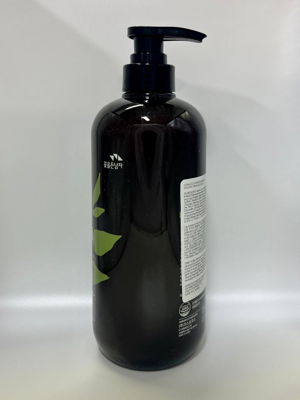 COSMOCOS Henna Hair Shampoo bottle on bathroom shelf in natural lighting.