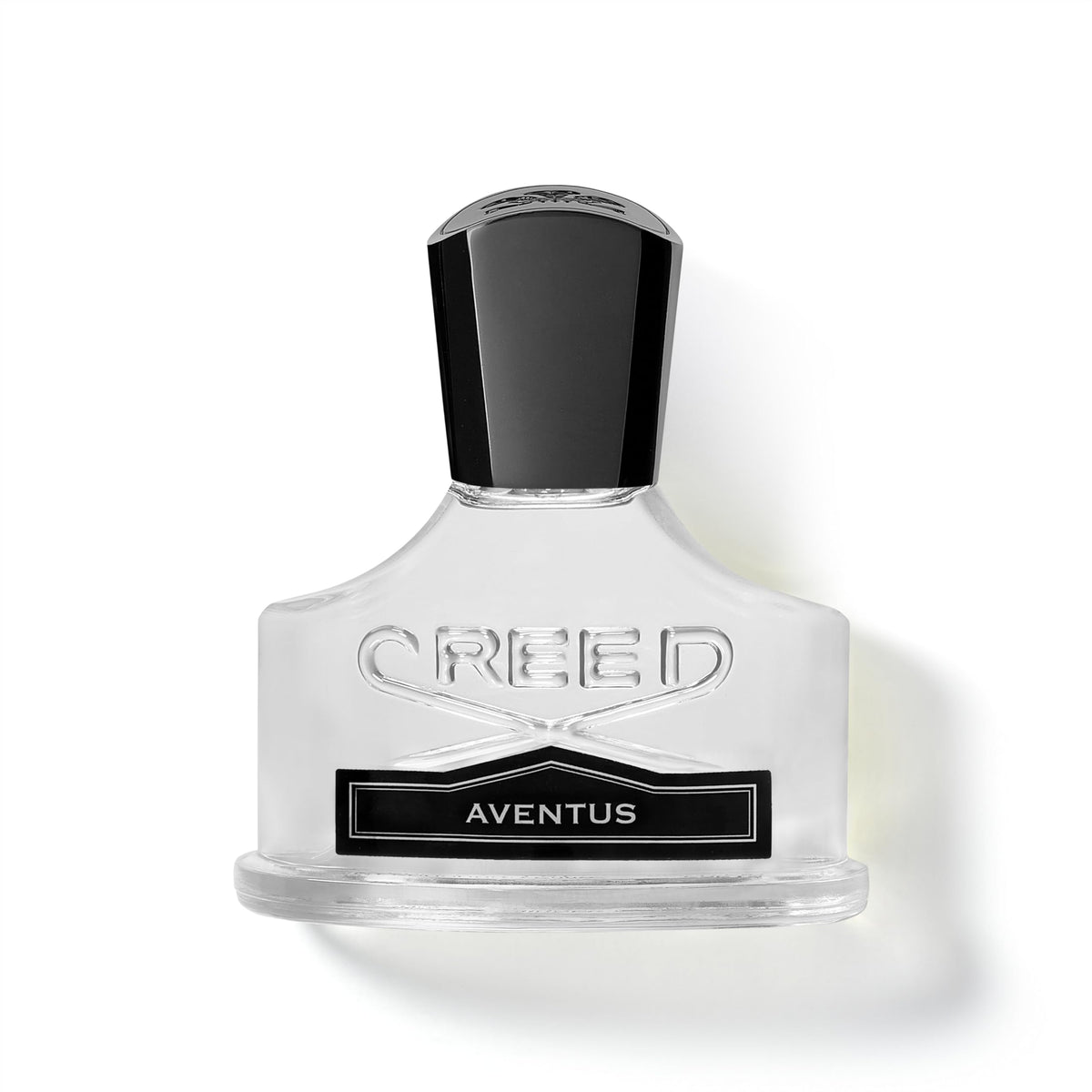 Creed Aventus bottle on dark wood, evoking premium daily luxury and confidence.