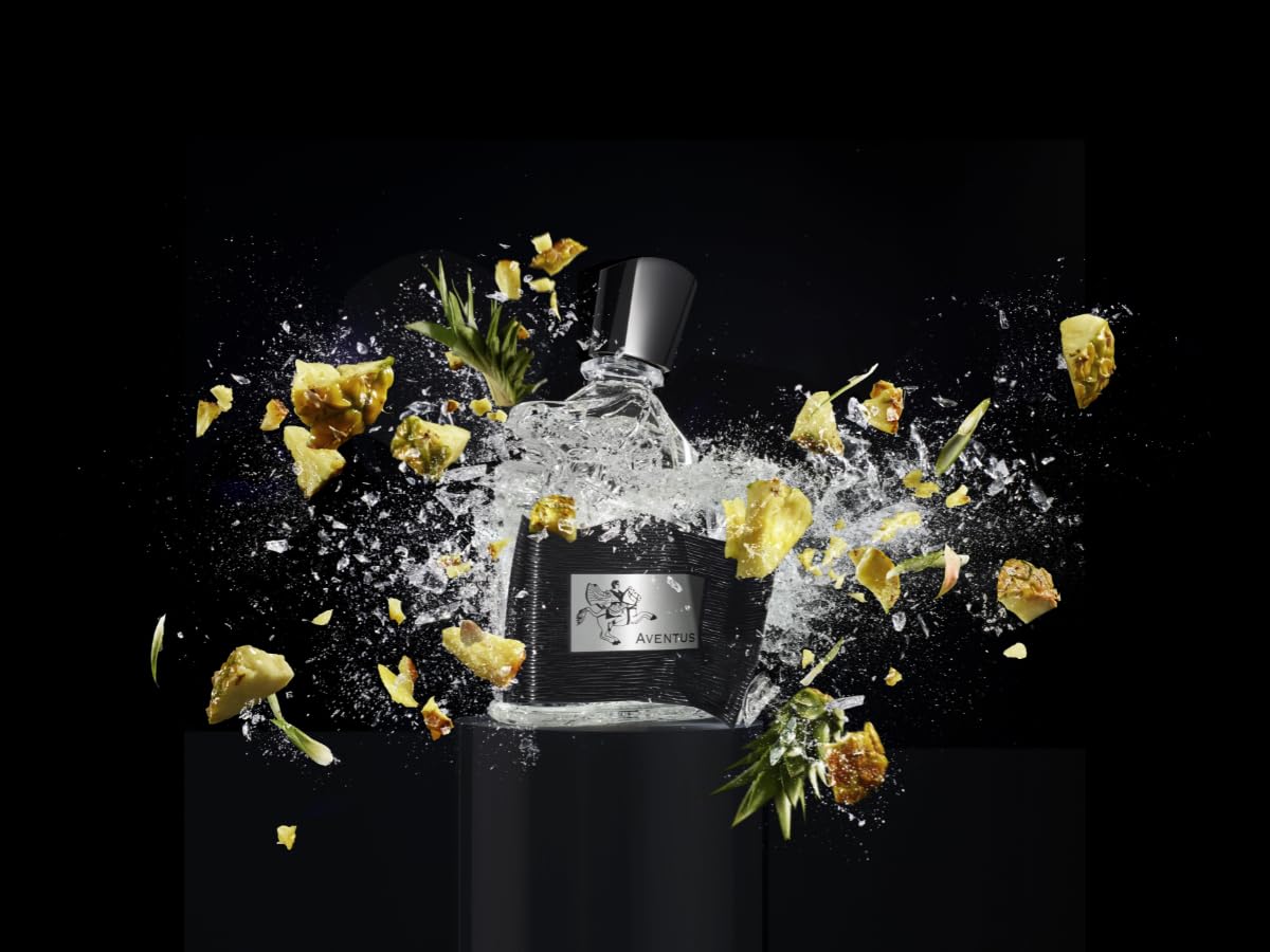 Aventus glass bottle with golden liquid glow, suggesting fresh opening.