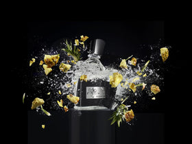 Aventus glass bottle with golden liquid glow, suggesting fresh opening.