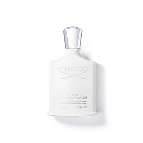 Creed Silver Mountain Water bottle cap gleams in light, premium fragrance presentation.