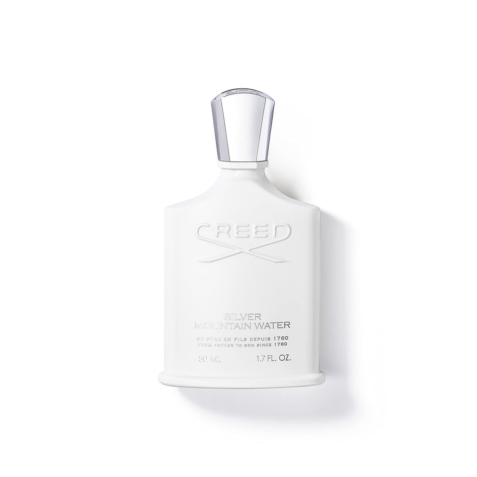 Creed Silver Mountain Water bottle cap gleams in light, premium fragrance presentation.