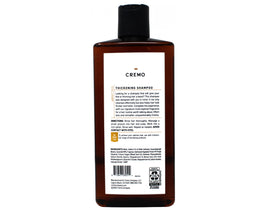 Cremo barber-grade bottle on shower shelf ready for daily volume boost.