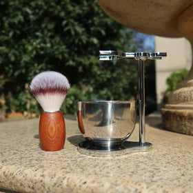 CRUCISRESIN wooden-handle detail adds classic touch to shaving ritual.